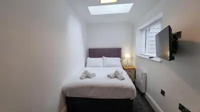 a bedroom with a bed with two pillows on it at Abergwaun APT 1 in Aberystwyth