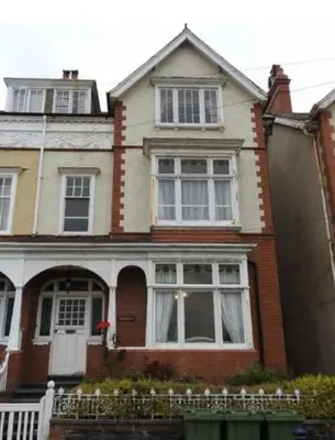 a house with a white door and windows at Abergwaun Apt 3 in Aberystwyth