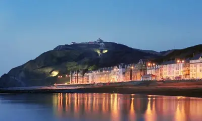 a building on the shore of a body of water at Abergwaun Apt 3 in Aberystwyth