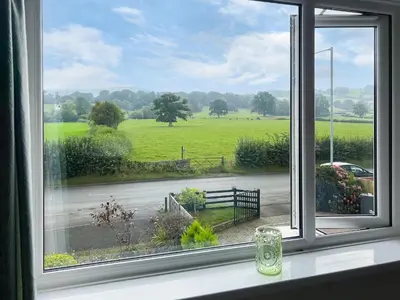 an open window with a view of a field at Mum's Place in Hay-on-Wye