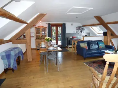 a living room with a blue couch and a table at Tollant in Rhayader