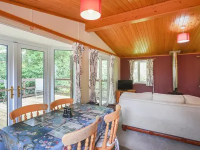 a bedroom with a bed and a table and chairs at The Squirrels Drey C32 - Uk45927 in Newtown