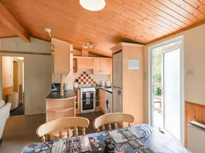 a kitchen with a table and chairs in a room at The Squirrels Drey C32 - Uk45927 in Newtown