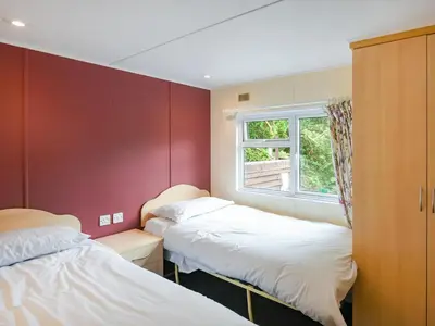two beds in a room with a window at The Squirrels Drey C32 - Uk45927 in Newtown