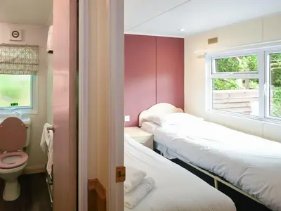 a room with three beds and a toilet and a window at The Squirrels Drey C32 - Uk45927 in Newtown