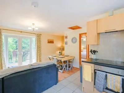 a kitchen with a table and a counter top at High Tide in Scyborycoed