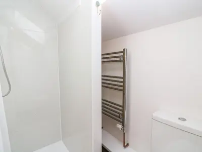 a bathroom with a walk in shower next to a toilet at Field View in Llanybydder