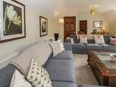 a living room with a couch and a table at Pennant Tigi Uchaf in Dolgellau