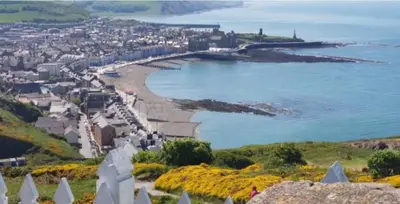 a view of a beach with a city and the ocean at Cozy 2 Bedroom Static Caravan in Clarach Bay , Aberystwyth in Aberystwyth
