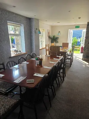 a dining room with wooden tables and chairs at The Royal Oak Inn, Rhandirmwyn in Rhandirmwyn