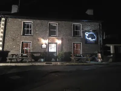 a brick building with a tv on the side of it at The Royal Oak Inn, Rhandirmwyn in Rhandirmwyn