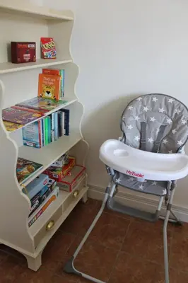 a high chair next to a book shelf at Shrewsbury Georgian town house - Hills Lane in Shrewsbury