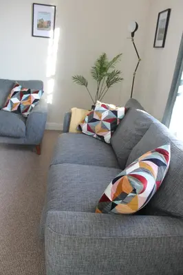 a couch with two pillows on it in a living room at Shrewsbury Georgian town house - Hills Lane in Shrewsbury