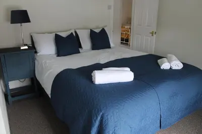 a bedroom with a large bed with towels on it at Shrewsbury Georgian town house - Hills Lane in Shrewsbury