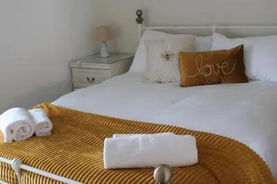a bedroom with a bed with towels on it at Shrewsbury Georgian town house - Hills Lane in Shrewsbury