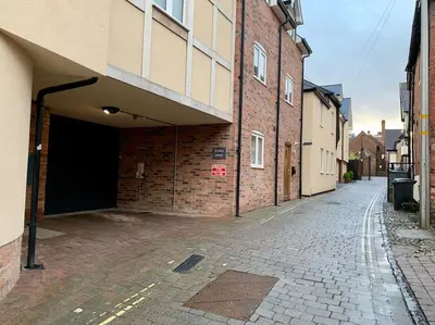 an empty alley with a building with a garage at The Stokesay Ludlow in Ludlow