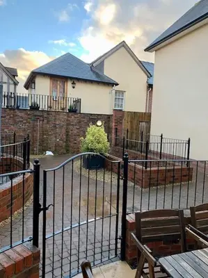 a black fence in front of a house at The Stokesay Ludlow in Ludlow