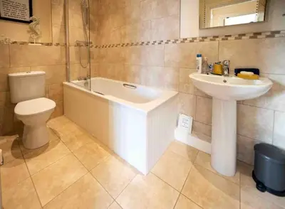 a bathroom with a sink and a tub and a toilet at The Stokesay Ludlow in Ludlow
