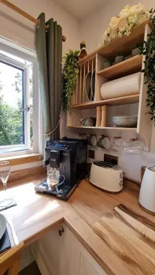 a kitchen with a coffee maker on a counter at The Duck House in Barmouth