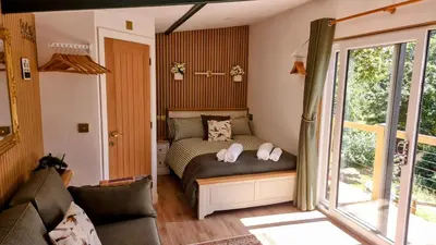 a bedroom with a bed and a couch at The Duck House in Barmouth