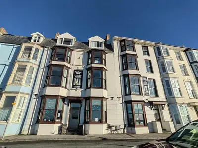 a large apartment building on a city street at Cardigan and Celtic Bay Guest House - Self Catering Accommodation in Aberystwyth