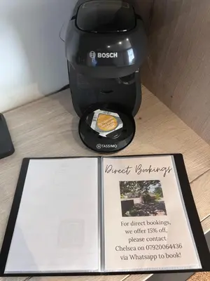 a sign sitting next to a food processor with a box at Luxury Courtyard Studio in Llangollen in Llangollen