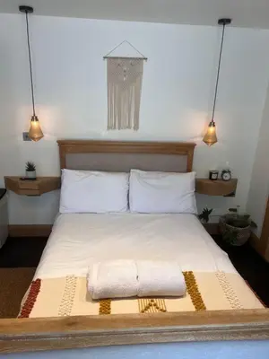 a bedroom with a bed with two towels on it at Luxury Courtyard Studio in Llangollen in Llangollen