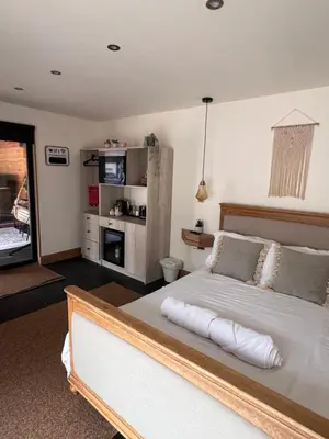 a bedroom with a large white bed in a room at Luxury Courtyard Studio in Llangollen in Llangollen
