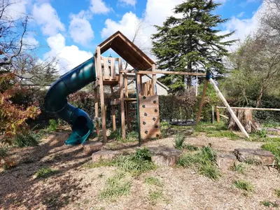 a playground with a slide in a yard at Garden View Apartment in Oswestry