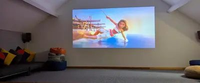 a picture of a girl on a screen on a wall at Family Home in Tywyn - Game and Cinema Rooms in Tywyn