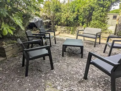a group of chairs and tables in a yard at Family Home in Tywyn - Game and Cinema Rooms in Tywyn