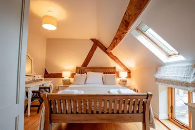 a bedroom with a large bed in a attic at Oak Barn, Ludlow in Ludlow