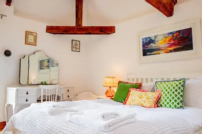 a bedroom with a bed with two towels on it at Oak Barn, Ludlow in Ludlow