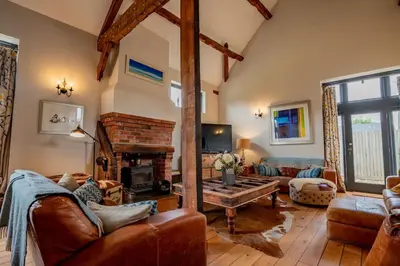 a living room with a couch and a fireplace at Oak Barn, Ludlow in Ludlow