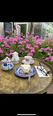 a table with a piece of cake and glasses on it at The Railway Carriage - Blue in Glasbury