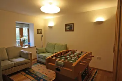 a living room with a foosball table at Henllys Lodge in Cilycwm