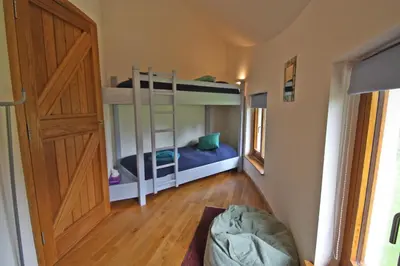 a room with two bunk beds and a door at Henllys Lodge in Cilycwm
