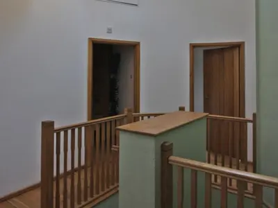 a room with a staircase with a counter and a door at Henllys Lodge in Cilycwm