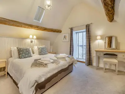 a bedroom with a large bed and a desk at Hares Hollow - Uk33953 in Llanymynech