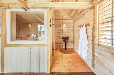 a sauna with a robe hanging on a wall at Ty Glyn Mansion Cottage in Ciliau-Aeron