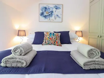 a bedroom with a large bed with towels on it at Bwthyn Camlan in Machynlleth