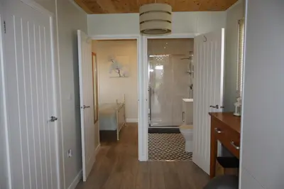 a bathroom with a shower and a toilet and a sink at Cabin Cynthia in Llwyngwril