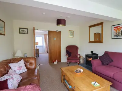 a living room with two couches and a coffee table at Nuthatch Cottage at Riverside Lodge in Rhayader