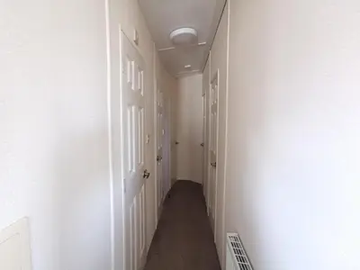 a hallway with white walls and a white door at Snowdonia Holiday Sea Beach and Mountains view in Llwyngwril