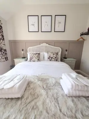 a bedroom with a white bed with two white towels on it at The Lilley Pad in Ludlow Cosy, Central, Perfect for Couples, Netflix & Parking Permit in Ludlow