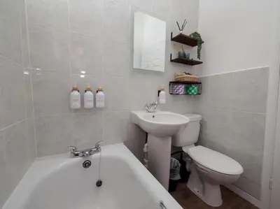 a bathroom with a toilet and a tub and a sink at The Lilley Pad in Ludlow Cosy, Central, Perfect for Couples, Netflix & Parking Permit in Ludlow