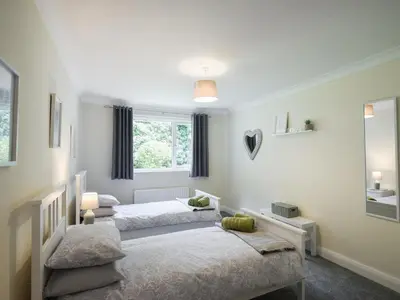 a bedroom with two beds and a window at The Bungalow in Castle Caereinion