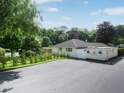 a house with a garage and a driveway at The Bungalow in Castle Caereinion