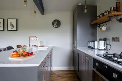 a kitchen with a white counter with a tray of fruit on it at Birch Banc Retreats - Glyn-Haul, New Enc Decking in Llanidloes
