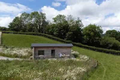 a small shed in a field with a hill at Birch Banc Retreats - Glyn-Haul, New Enc Decking in Llanidloes